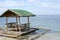 Floating beach bamboo and palm cottage parasol on white sand coast