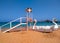 floating boats with swan shape at the shore of a beach ready to be hired by tourists and close to place for lifeguards to watch