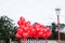 A floating bouquet of red, heart-shaped balloons