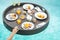 Floating Breakfast tray in swimming pool at luxury hotel or tropical resort villa, fruits; mango, watermelon dragon and passion