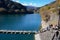 Floating bridge made of drum containers in a blue lake in Okutama, Japan, sunny autumn day