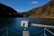 Floating bridge made of drum containers in a blue lake in Okutama, Japan, sunny autumn day