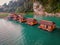 Floating bungalows at Khao Sok Thailand, drone view at the lake with couple in front of bungalow