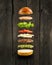 Floating burger ingredients on the wooden background