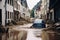 Floating cars in the water during flooding in an european country, with washed out street