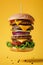 Floating Cheeseburger with Multiple Patties Against Yellow Background