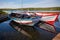 Floating Color Wooden Boats with Paddles in a Lake