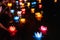 Floating colored lanterns and garlands on river at night on Vesak day for celebrating Buddha\'s birthday in Eastern culture, that