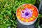 Floating colorful decorative flowers in a bowl of water