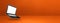 Floating computer laptop isolated on orange. Horizontal banner background