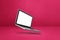 Floating computer laptop isolated on pink. Horizontal background