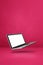 Floating computer laptop isolated on pink. Vertical background