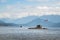 Floating dock in the middle of the bay near Gibsons, BC, with a speed boat in the background.