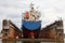 Floating dry dock with blue industrial tanker ship