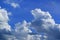 Floating fluffy cumulus clouds on vibrant blue sky