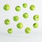 Floating green apples on white background