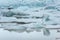 Floating icebergs melting in Fjallsarlon glacier lake, Iceland