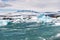 Floating icebergs and view to the glacier, ice lagoon Jokulsarlon, Iceland