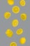 Floating levitating fresh lemon on ultimate gray background