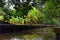 Floating Market by Bangkok Thailand, Damnoen Saduak. Views from tour boat of local sales shops, canals and vegetation landscape.