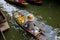 Floating market in Thailand with Trader hat