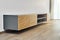 Floating media cabinet in contemporary living room. Wall mounted wooden cabinet