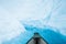 Floating through a narrow canyon cut from glacier ice of the Matanuska Glacier in Alaska. The canyon is flooded with melting