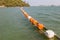 Floating orange and white buoys for marking safety zone.