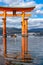 Floating red giant Grand O-Torii gate stands in Miyajima island bay beach