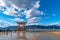 Floating red giant Grand O-Torii gate stands in Miyajima island bay beach