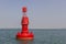 Floating red navigational buoy