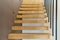 Floating stairs. Wooden steps attached to wall in modern building