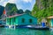 Floating village near rock islands in Halong Bay