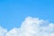 Floating white clouds and bright blue sky background