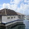 Floating wooden house moored in the Caribbean port. Tropical architecture