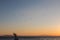 Flock of birds flying over a sculpture on Passignano Trasimeno