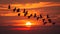 A flock of birds soars through the sky in perfect unison their synchronized movements a mesmerizing sight against the