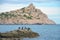 A flock of birds on a stone in the sea and Cape Kapchyk, Crimea, Novy Svet
