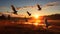 A flock of birds taking flight over a vast open field.