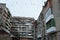 Flock of flying birds above old soviet concrete apartment houses windows and balconies