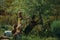 Flock of goats grazing on green leafy tree