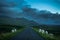 Flock Of Grazing Sheep And Lamb Beneath Lonesome Single Track Road Through Mountain Landscape Near Rhiconich In Scotland