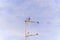 A flock of Laundress birds on a TV antenna against stunning blue sky with clouds