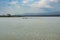 A flock of lesser flamingos and pelicans  at Lake Elementaita against the background of Sleeping Warrior Hill, Kenya