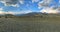 Flock of mountain goat and sheep grazing on a lawn in the mountains in autumn day. Panoramic view.