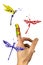 Flock of painted dragonflies flying around finger