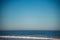 Flock of pelicans above waves on Oregon coast