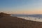 Flock of seagulls on deserted beach at sunrise