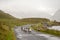 Flock of sheep running on a small asphalt road. Connemara, Ireland. Background in a fog. Nature background. Travel and agriculture