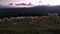 Flock of sheep walking through the mountain at sunset